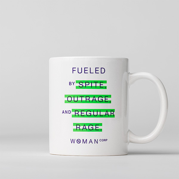 A coffee mug with the slogan 'Fueled by spite, outrage, and regular rage. Woman Corp' that is available for purchase at the ERA Coalition online store